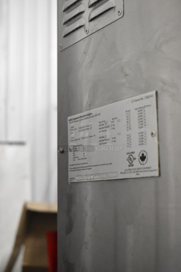 Hardt Inferno 3500 commercial rotisserie oven, stainless steel, natural gas, skewers, on casters. Manufacturer's label visible.