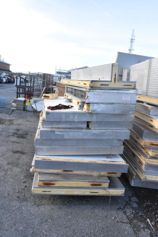 Two Penn walk-in boxes stacked outdoors, missing compressors, condensers, and evaporator fans. Sold as a combo unit.