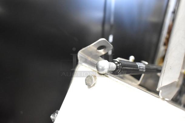 Oliver 797-32NC metal commercial bread slicer detail view, focusing on the corner bracket and a bolt.