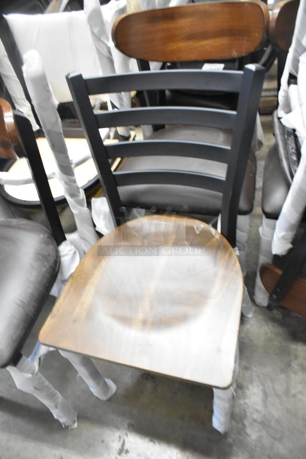 23 new scratch and dent chairs, including Lancaster Table & Seating 164CMTLADFR. Black metal, wood backrest, slat arm design.