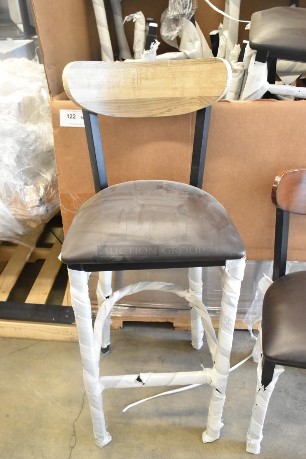 Brand new black metal chair with wooden backrest and cushioned seat. Includes dining and bar height options. Scratch and dent condition.