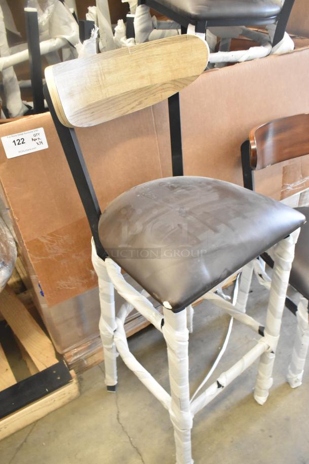 14 new black metal chairs with wooden backrests, cushioned seats, dining and bar height, some scratch and dent.