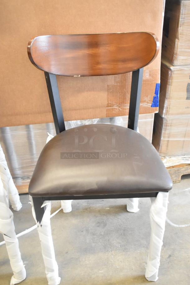 Black metal chair, brand new, with a wooden backrest and cushioned seat. Scratch and dent condition. Dining and bar height options.
