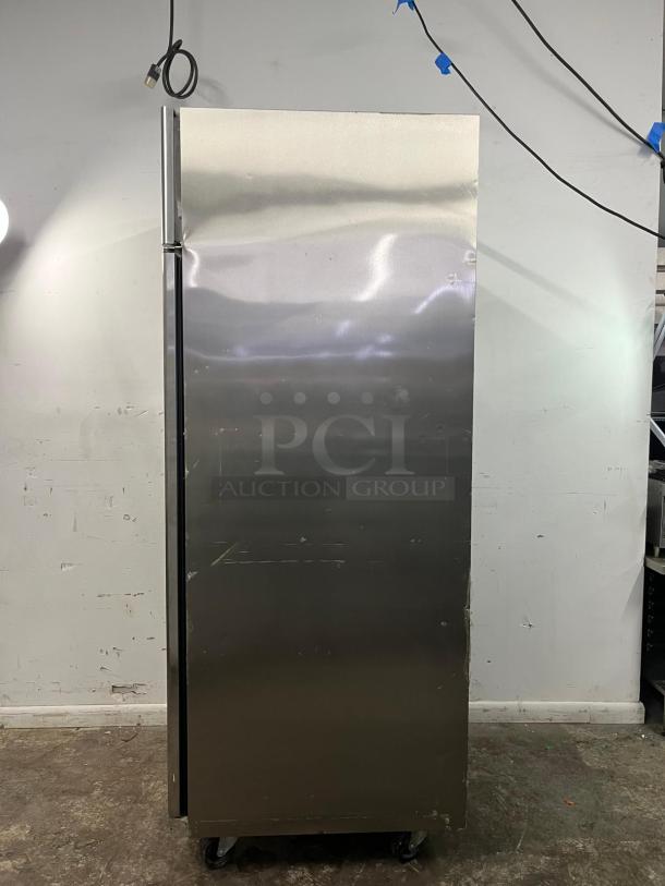 Commercial-grade Everest ESF1 one-section reach-in freezer, stainless steel, visible wear, on casters, by Everest Refrigeration.