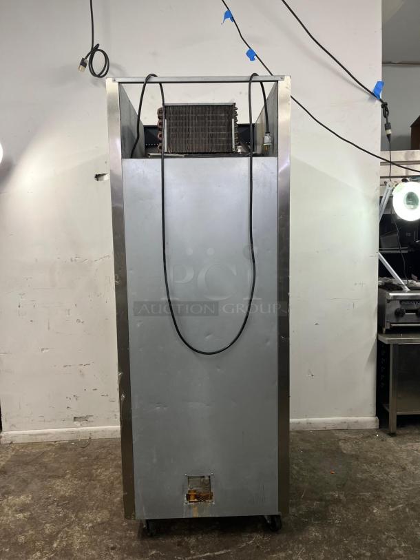 Everest ESF1 commercial-grade reach-in freezer, one-section, sturdy metal exterior, visible wires, on casters, rear view.