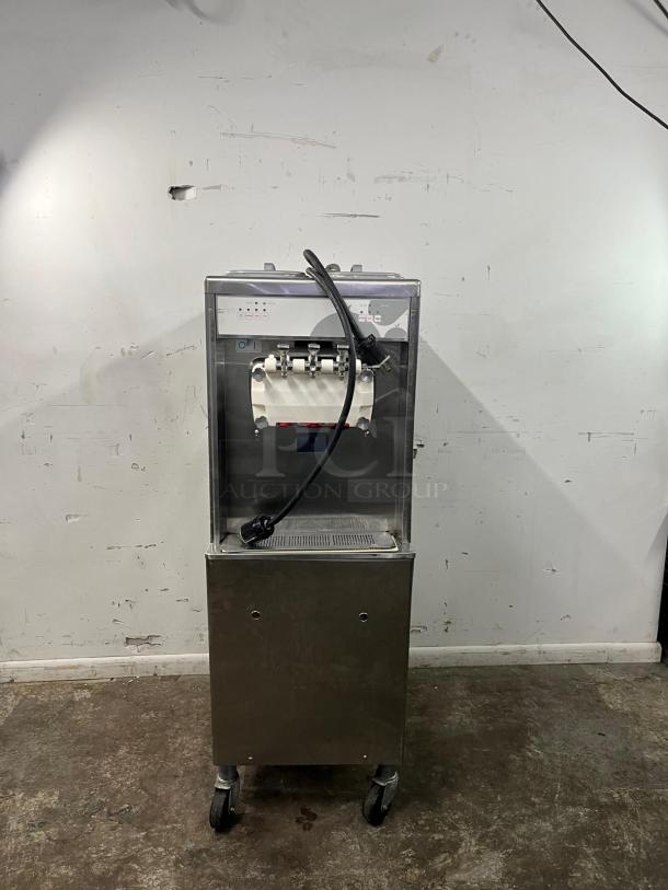 TAYLOR 794-33 soft serve ice cream machine in good condition, stainless steel with caster wheels, power cord attached.