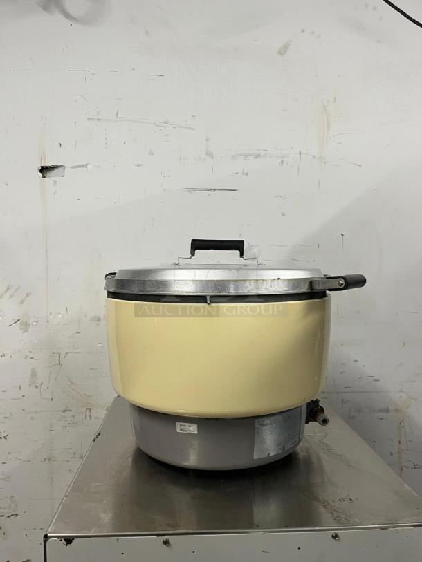 Rinnai RER55ASN 55-cup natural gas rice cooker, beige exterior, visible condition wear, with control panel and connection valve.