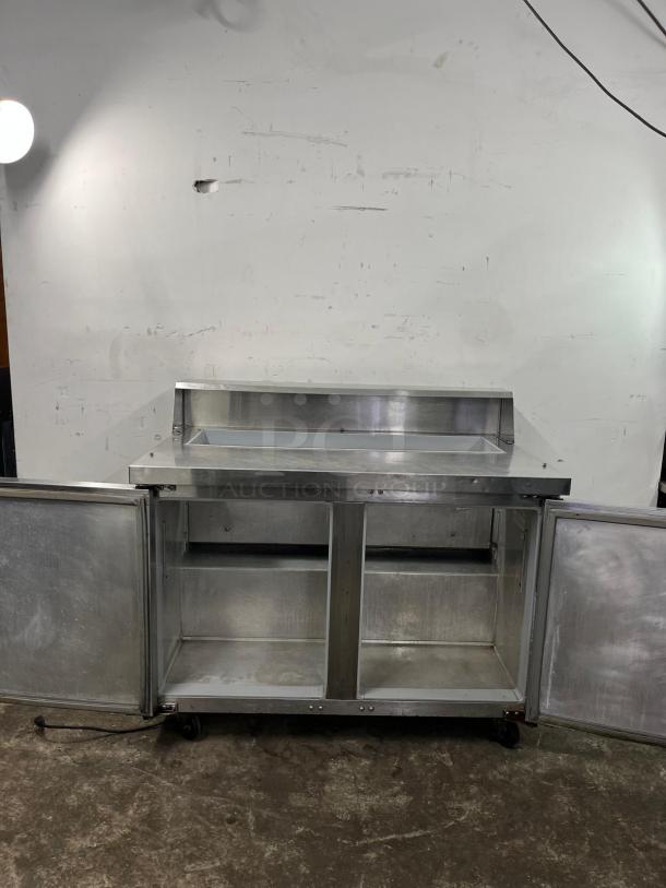 Continental SW48-12 refrigerated sandwich prep unit, 48" width, 13.4 cu ft capacity, stainless steel, open doors, good condition.