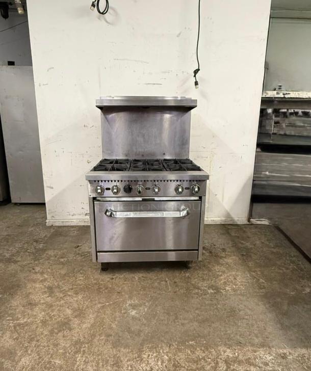 ACE GR-36/NG 6-burner oven in excellent condition, stainless steel, commercial use, visible dials and spacious oven door.