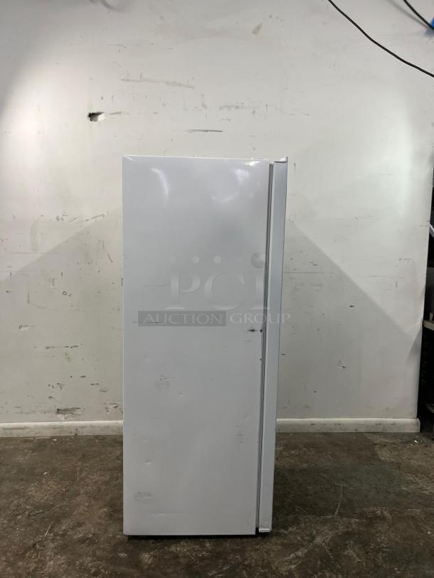 INSIGNIA 7 Cu. Ft. Upright Convertible Freezer NS-UZ70WH4 in white. Visible dents and scratches on side panel.