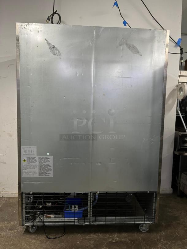 DUKERS D55R 55" reach-in refrigerator, stainless steel, 2 sections, visible wear, labels with safety instructions.