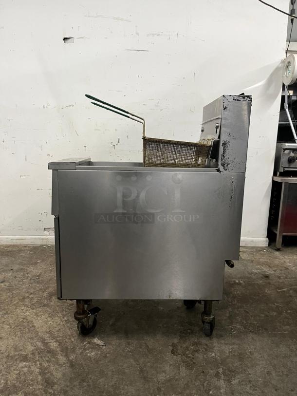 PITCO SG14-S gas fryer, 50 lb vat, floor model, natural gas, stainless steel, visible wear, on casters, mesh fry basket included.
