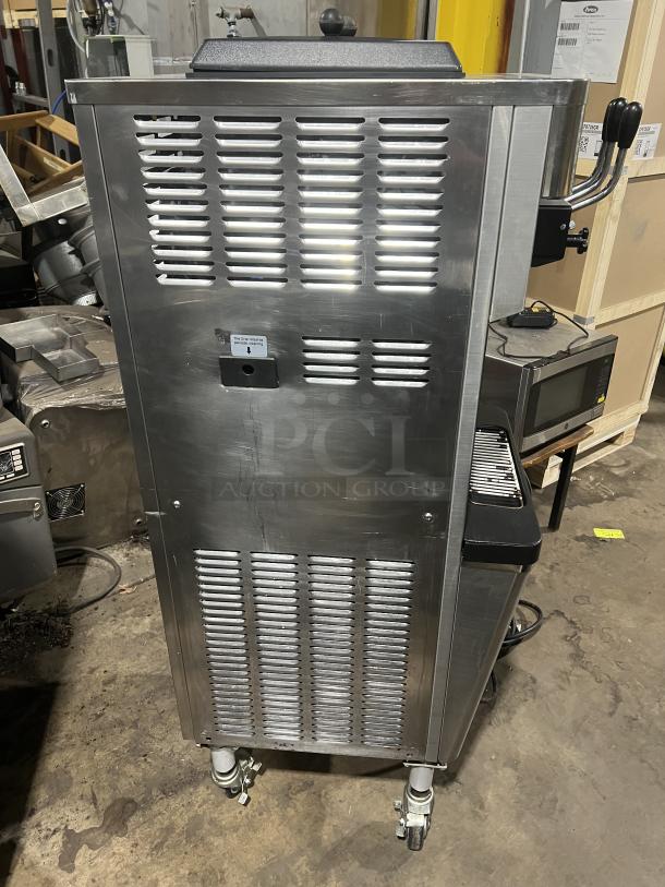 Well Spring SSI-143S stainless steel soft serve machine, twin hoppers, three dispensers, digital controls, on casters.