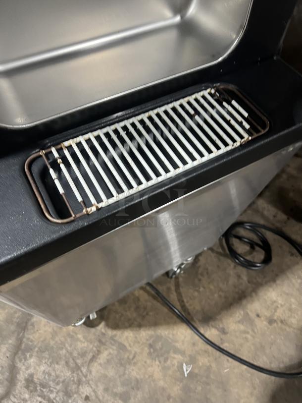 Well Spring SSI-143S soft serve machine with stainless steel exterior, drip tray, and casters. Model SSI-143S, 220V, 1 phase.