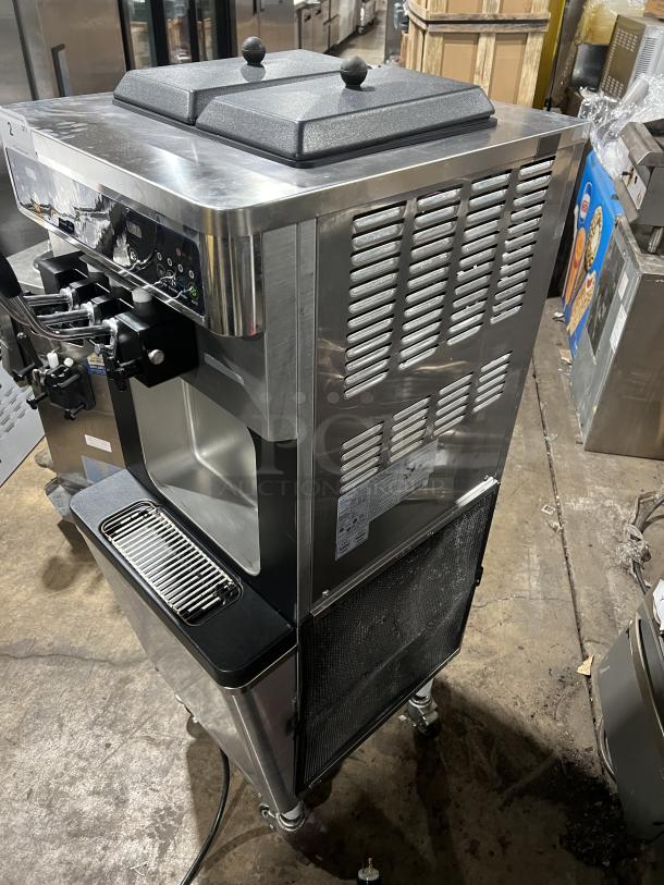 Well Spring SSI-143S stainless steel soft serve machine with 2 hoppers, 3 dispensers, digital controls, drip tray, and casters.