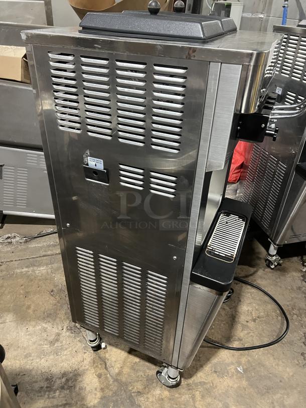 Well Spring stainless steel twin soft serve machine, model SSI-143S, with 2 hoppers, 3 dispensers, on casters, 220V.