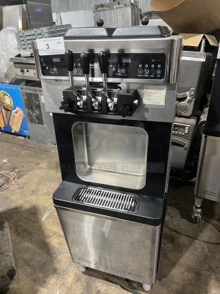 Well Spring SSI-143S stainless steel soft serve machine, 2 hoppers, 3 dispensers, digital controls, drip tray, on casters.