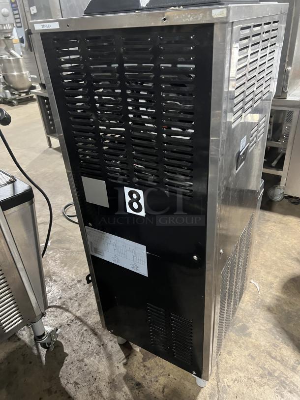 Well Spring SSI-143S stainless steel soft serve machine with 2 hoppers, 3 dispensers, drip tray, digital controls, on casters.