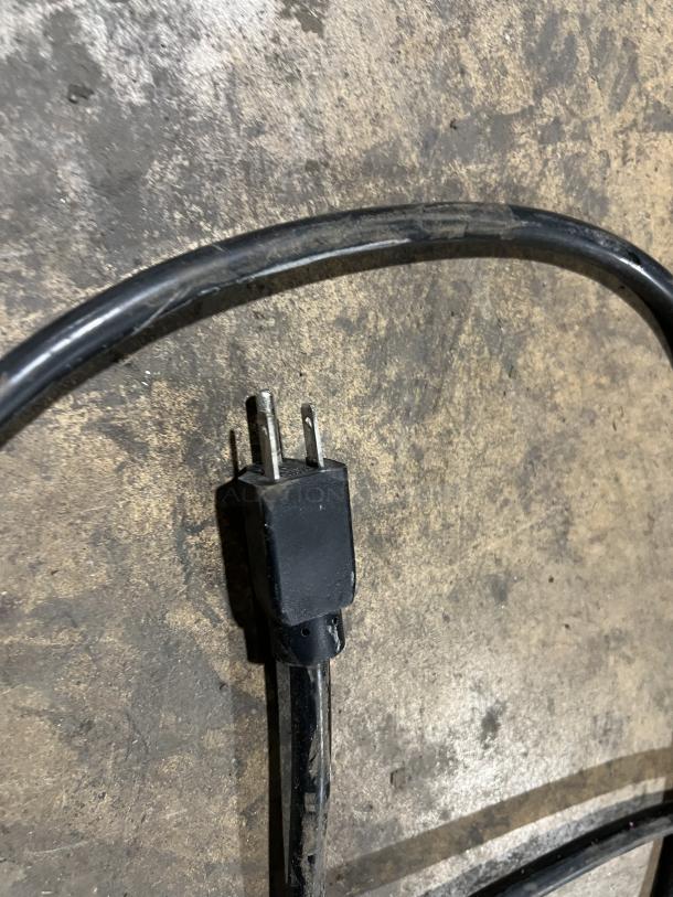 Plug and cord of Vevor YKF-8218T soft serve ice cream machine, showing standard 110V power connection.