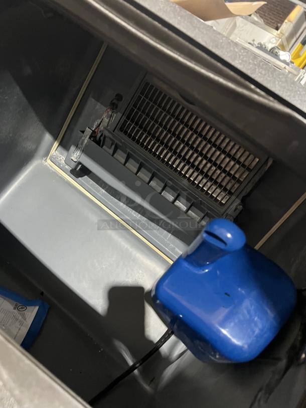 Manitowoc NEO Series UY0140A-161B ice machine interior, showing cooling components. Electric, air-cooled, on casters.