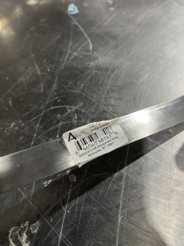 NEW Adcraft Stainless Steel 12 Oz Ladle, Model LD-12. Features barcode and label indicating "Made in India."