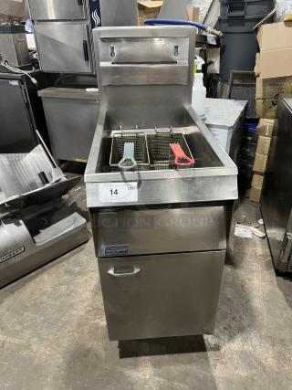 Pitco stainless steel natural gas deep fryer with two fry baskets, basket hanger, backsplash, and casters; used condition.