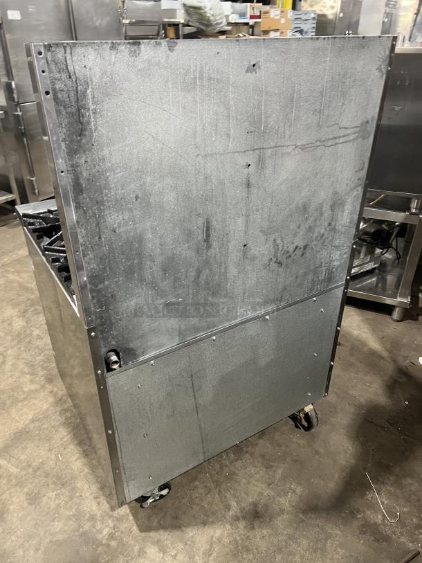 Turbo Air Radiance Series 6 Burner Range/Oven Combo, stainless steel, on casters, natural gas powered, with backsplash.