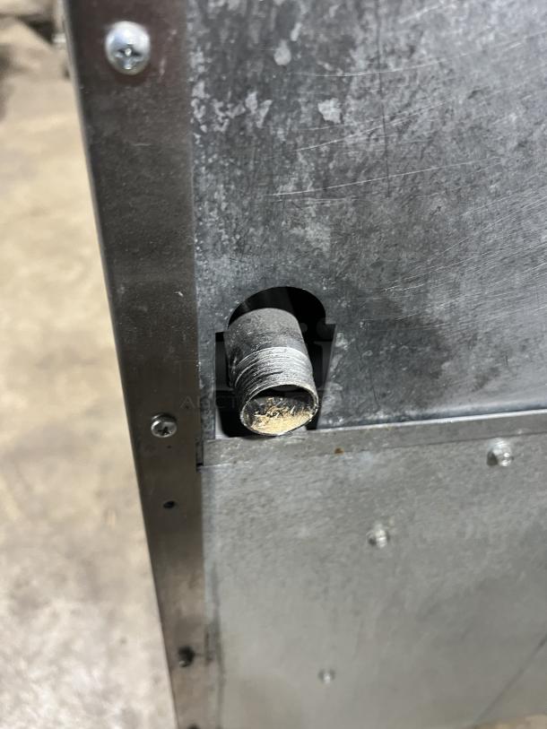 Close-up of the Turbo Air Radiance Series gas range connection point, highlighting metal surface and attachment details.