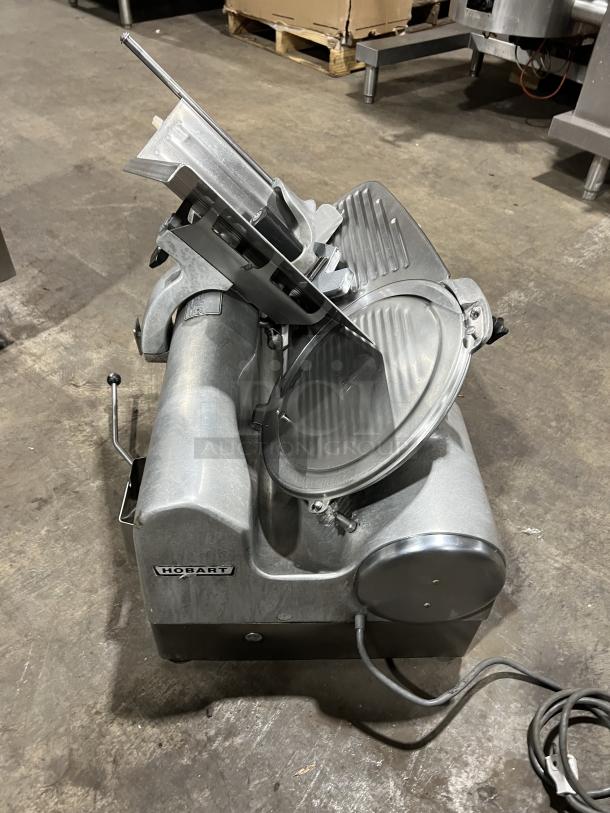 Hobart 1712 commercial meat slicer, stainless steel, electric, 115V, 1 phase, countertop, on legs, used condition.