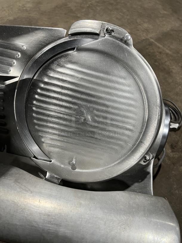 Hobart 1712 stainless steel deli meat slicer, electric, countertop model, 115V, on legs, in good condition.