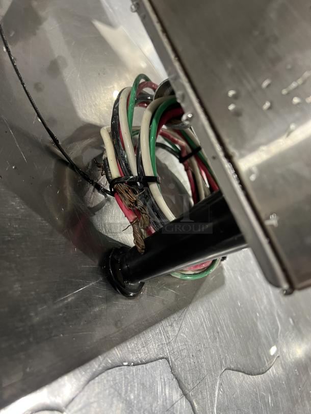 Close-up of wiring under Bunn ThermoFresh Series Dual Coffee Brewer, Model DUALTFDBC, showing cables and connectors.