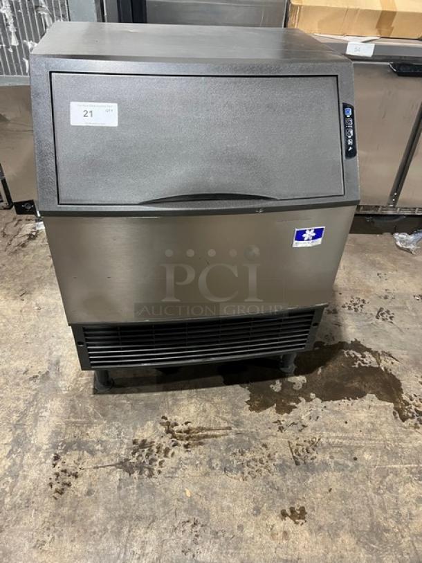 Manitowoc stainless steel undercounter ice machine, electric-powered, SN: 310466826, 115V, on legs, excellent condition.