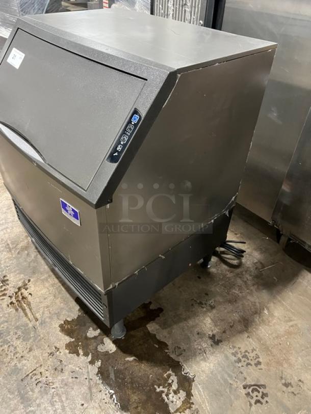 Manitowoc undercounter stainless steel ice maker/bin combo, electric powered, SN: 310466826, 115V, 1 phase, on legs.