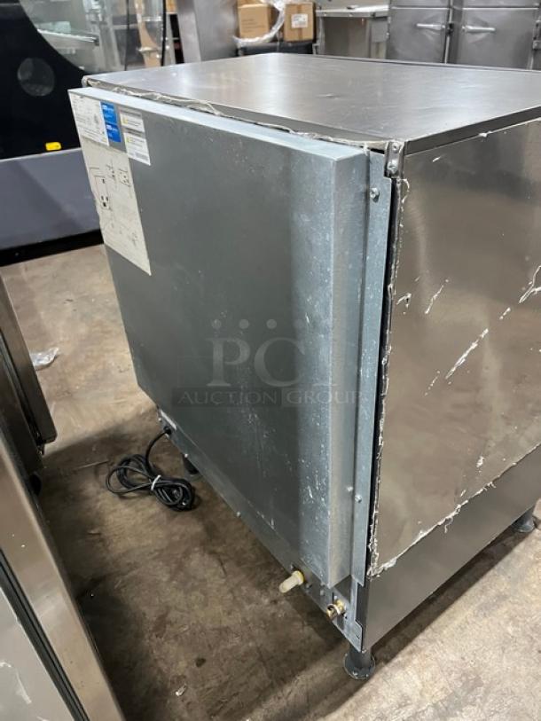 Manitowoc undercounter ice maker, stainless steel, SN: 310466826, 115V, 1 phase, on legs. Some surface wear visible.