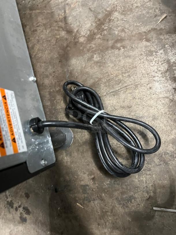 Manitowoc stainless steel undercounter ice maker, electric, on legs, SN: 310466826, 115V, 1 phase, visible power cord.