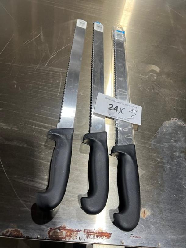 Three commercial stainless steel serrated kitchen knives with black grip handles, brand new condition, on a reflective surface.
