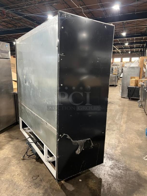 IRS Orchid76SL1800 commercial refrigerated display case, black, multi-tier, adjustable shelving, visible wear, model information on side.