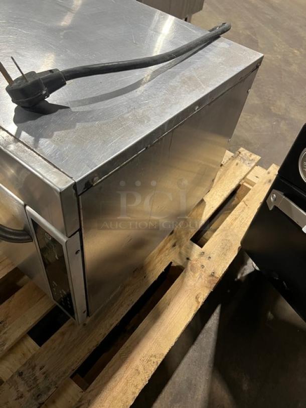 2011 Amana AXP20 Stainless Steel Rapid Cook Oven with wired racks, electric powered. Used, with visible power cord.