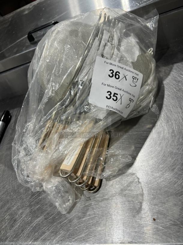 Adcraft commercial stainless steel strainer with wooden grip handle, new in packaging with auction tags visible.