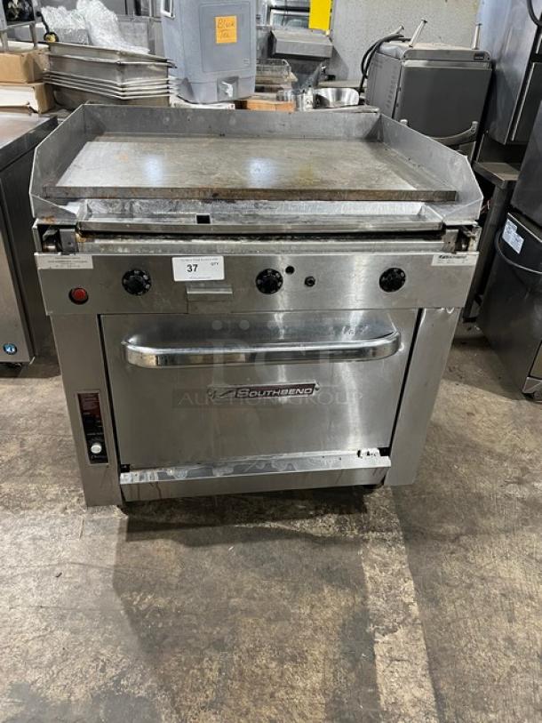 Southbend stainless steel natural gas flat-griddle top range & oven combo, Model P36ATTT, SN: 25B17419, on casters, with wired oven racks.