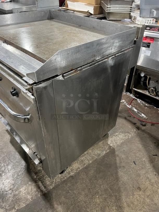 Southbend stainless steel flat-griddle top range and oven combo, model P36A-TTT, on casters, features wired oven racks.