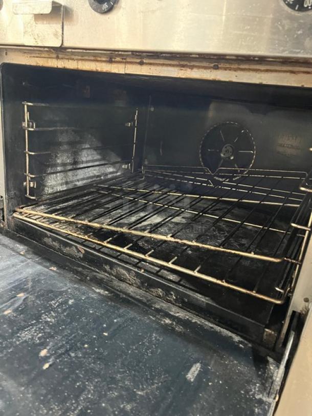 Southbend stainless steel gas flat-griddle range with oven, model P36A-TTT. Features wired racks, on casters, SN: 25B17419.