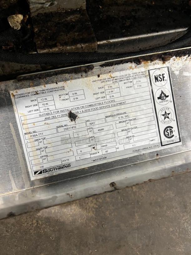 Southbend stainless steel flat-griddle top range and oven combo, model P36A-TTT, with wired racks and visible labels.