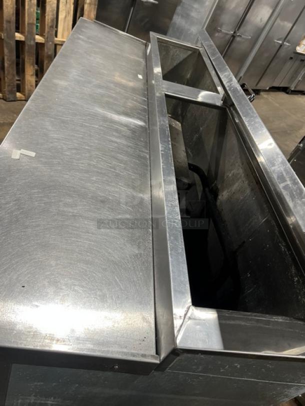 Universal Cooler 3-door stainless steel pizza prep table with poly-coated wire rack, on casters. Commercial use.