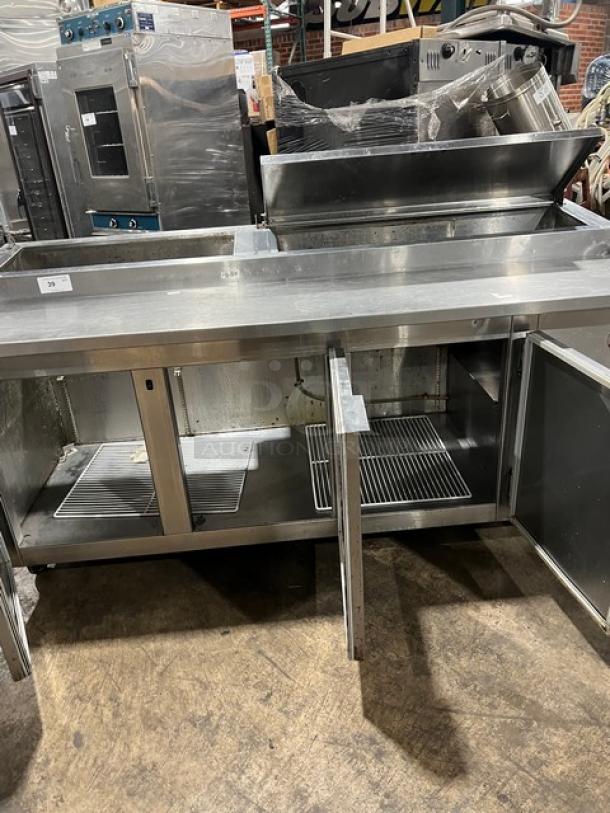 Universal Cooler stainless steel 3-door pizza prep table with poly-coated wire rack, on casters. Good condition.