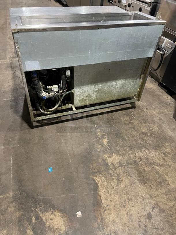 Commercial stainless steel single door refrigerated pizza prep table with chrome-plated wired rack, on casters. Used condition.