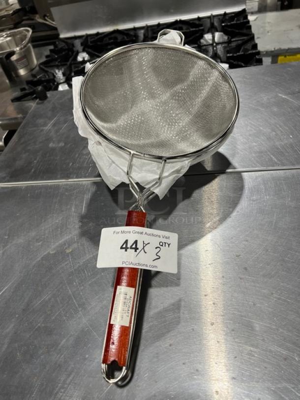 Adcraft DSM-10 deluxe 10" double mesh strainer with red wooden handle, new condition, includes auction label.