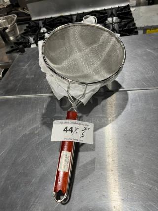 Adcraft DSM-10 deluxe 10" double mesh strainer with red wooden handle, new condition, includes auction label.