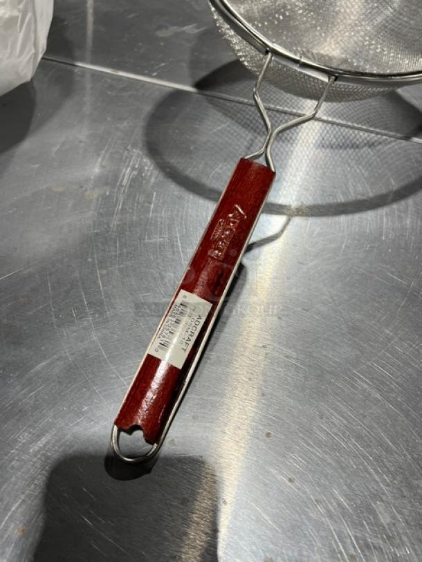 Adcraft Deluxe 10" double mesh strainer, model DSM-10, new condition. Wooden handle with brand label.