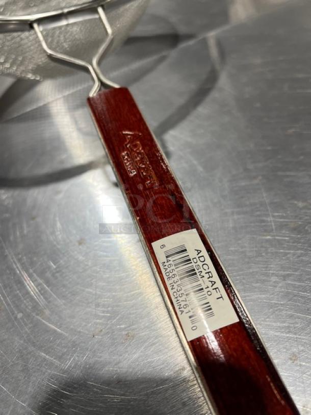 Adcraft Deluxe 10" Double Mesh Strainer, Model DSM10, new condition, wooden handle with visible label.